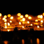 Candles. Set of lighting candles in dark. Selective focus
